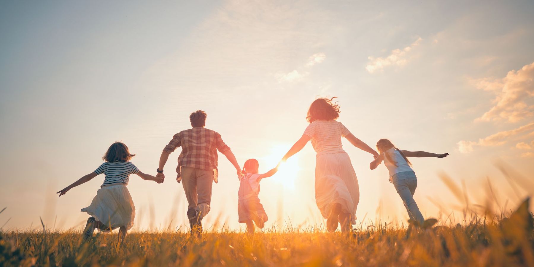 A family running together at sunset
